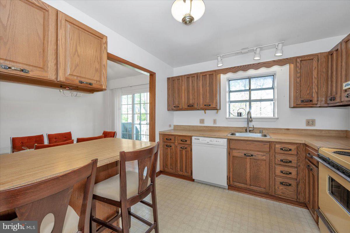 1300 Holliben Road Severna Park, MD 21146 - Photo 17 of 69 a open kitchen with stainless steel appliances granite countertop a stove top oven a sink dishwasher and white cabinets with wooden floor