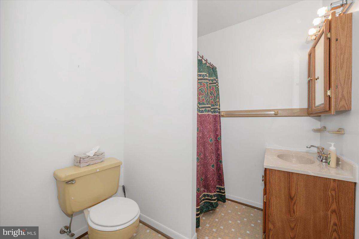 1300 Holliben Road Severna Park, MD 21146 - Photo 25 of 69 a bathroom with a toilet a sink and mirror