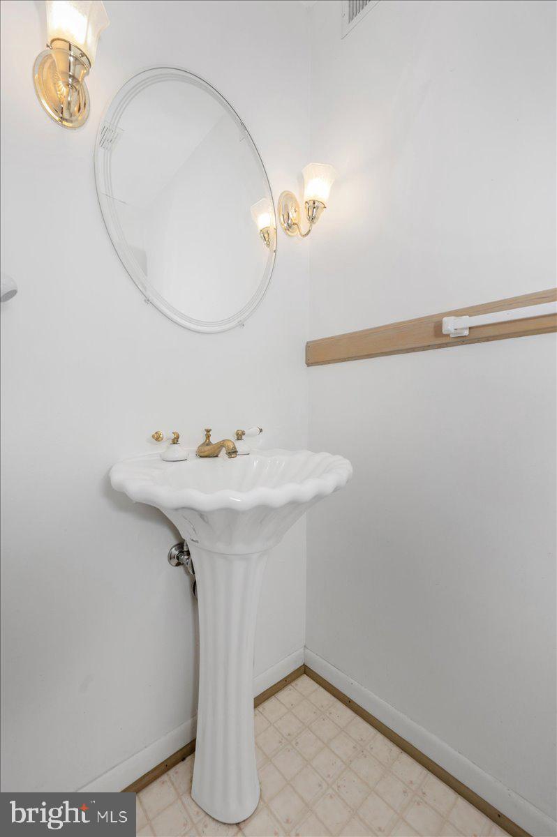 1300 Holliben Road Severna Park, MD 21146 - Photo 39 of 69 a bathroom with a sink and a mirror