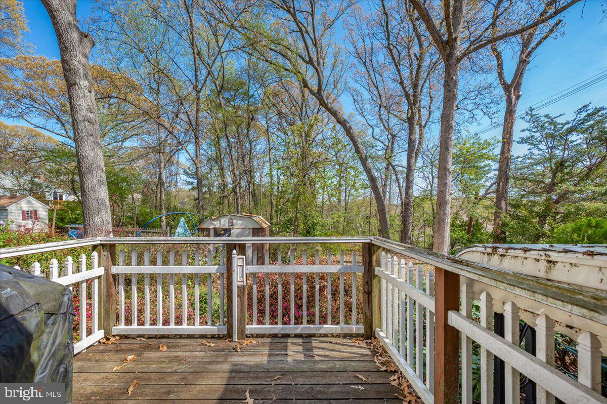 1300 Holliben Road Severna Park, MD 21146 - Photo 51 of 69 a view of a deck with large trees and wooden fence