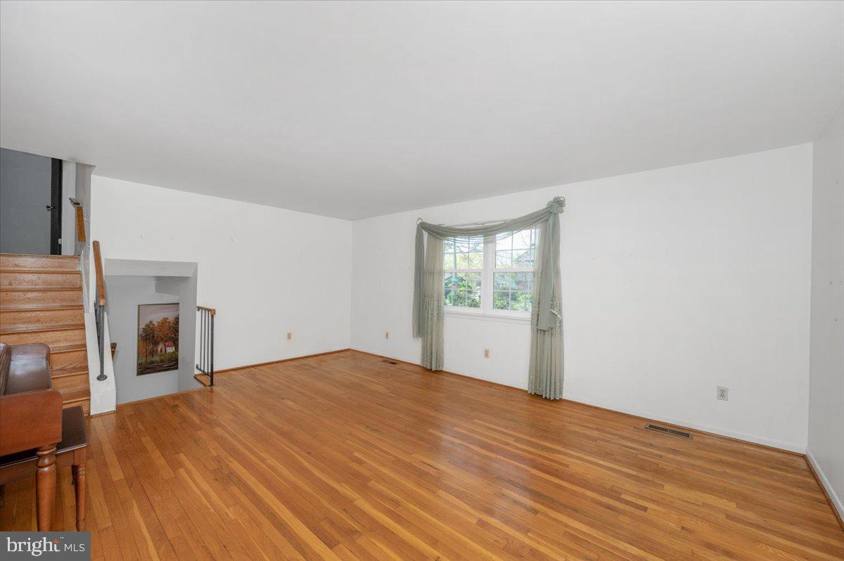 1300 Holliben Road Severna Park, MD 21146 - Photo 8 of 69 a view of an empty room with a fireplace and a window