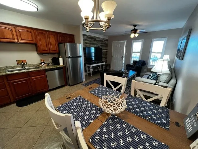 a kitchen with stainless steel appliances granite countertop a stove refrigerator and cabinets