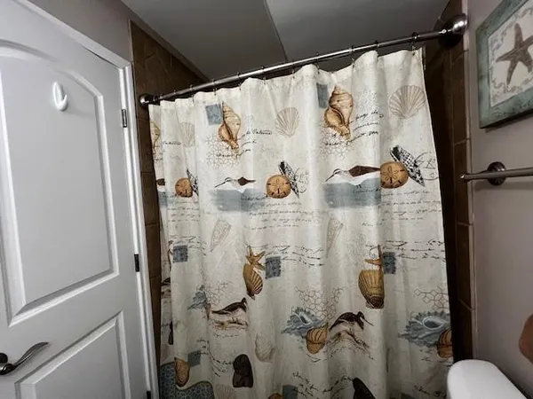 a white bath tub sitting next to a white sink and toilet