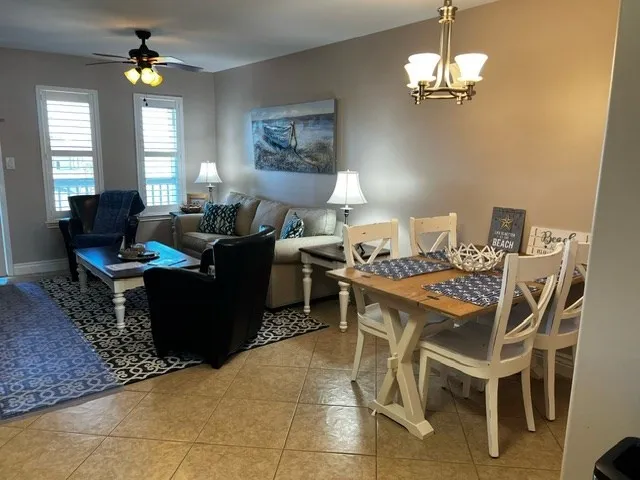 a living room with lots of furniture and a chandelier