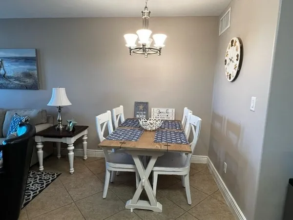 a view of a dining room with furniture and chandelier