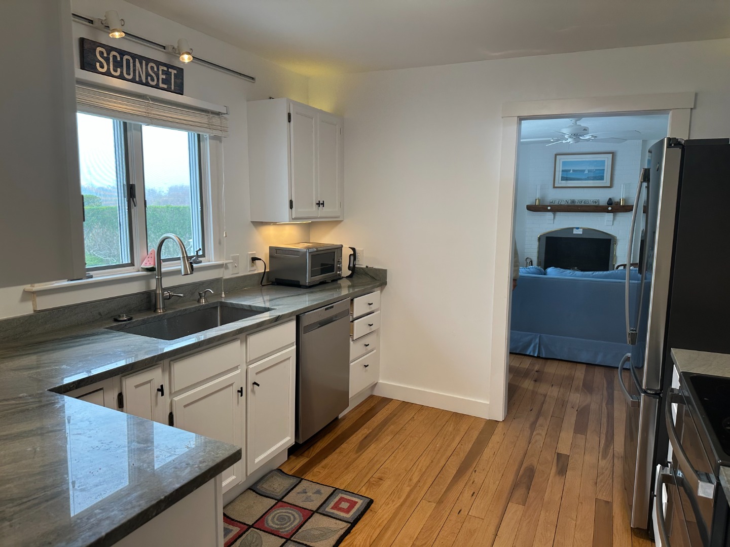 78 Baxter Road Nantucket, MA 02554 - Photo 7 of 14 a kitchen with stainless steel appliances granite countertop a sink stove and cabinets