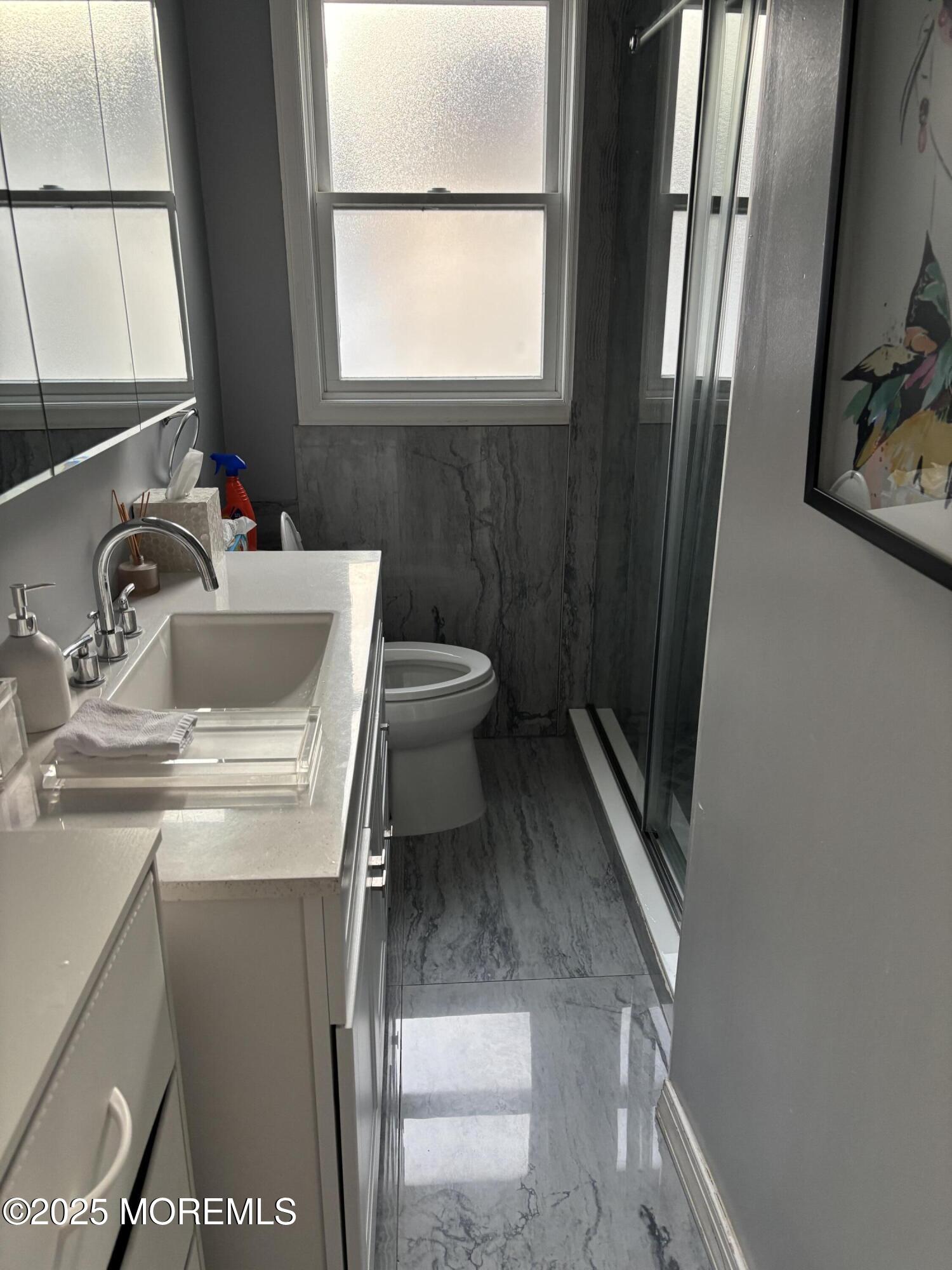 295 Roosevelt Avenue Oakhurst, NJ 07755 - Photo 15 of 16 a bathroom with a sink toilet and mirror