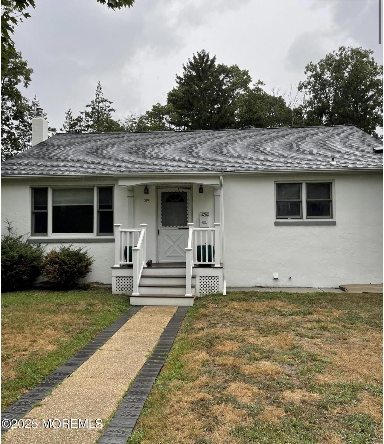 295 Roosevelt Avenue Oakhurst, NJ 07755 - Photo 2 of 16 a front view of a house with garden