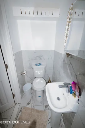 a kitchen with granite countertop a stove a sink and a refrigerator