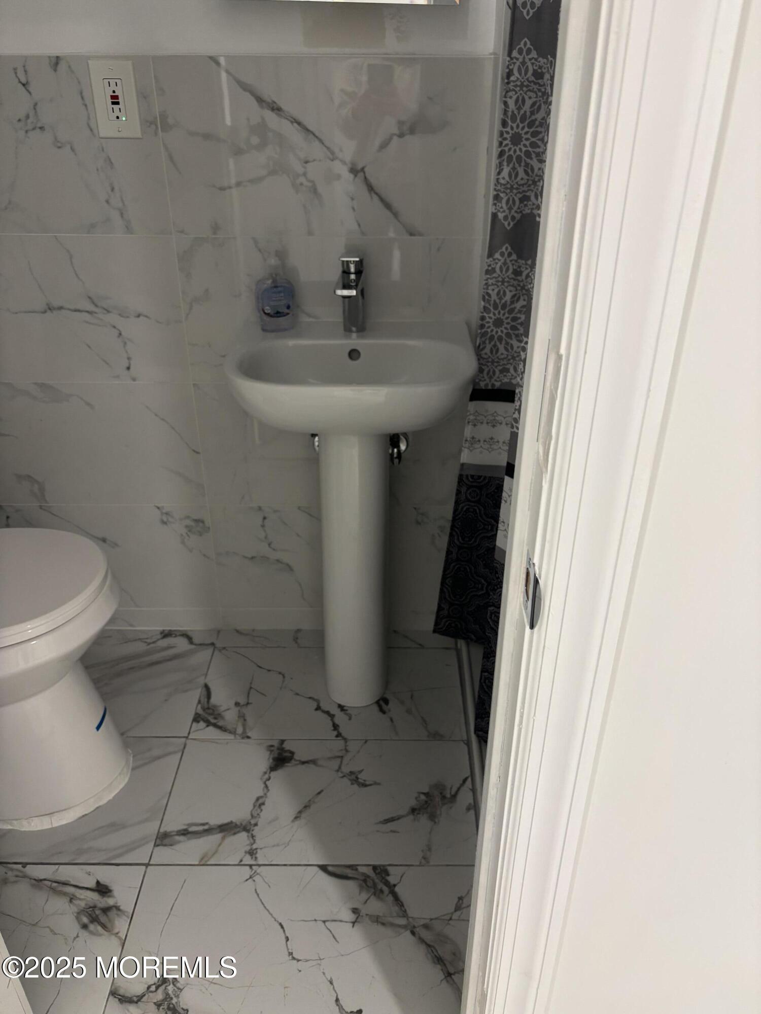 295 Roosevelt Avenue Oakhurst, NJ 07755 - Photo 10 of 16 a bathroom with a sink and toilet