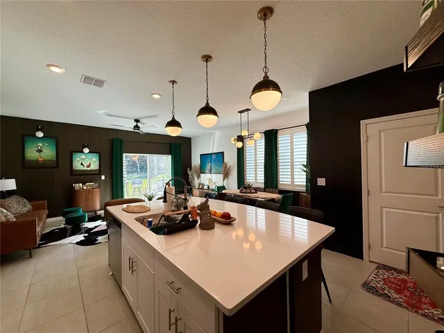 a kitchen with a table chairs and a chandelier