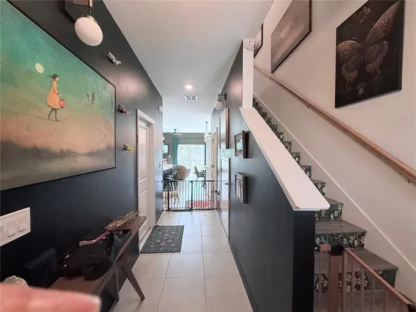 a hallway with furniture and wooden floor
