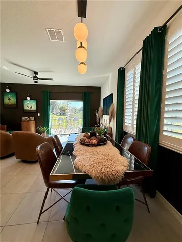 a living room with furniture lamp and window