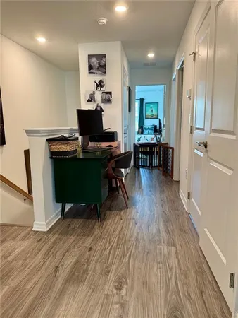 a workspace with furniture wooden floor and a window