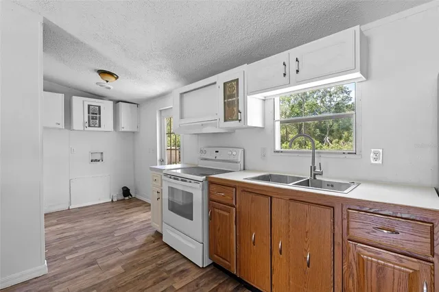a kitchen with a sink stove and cabinets