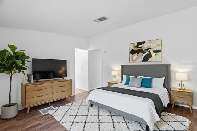 a bedroom with furniture and a flat screen tv