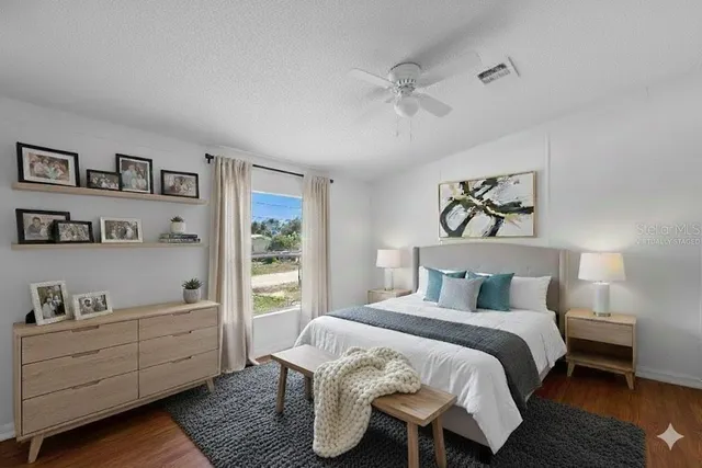 a bedroom with a bed and a window