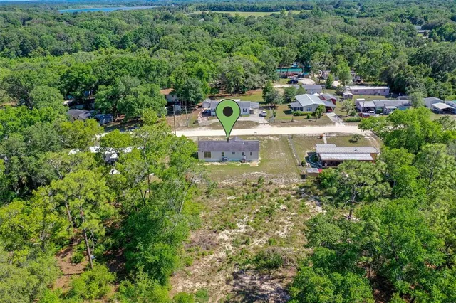 a view of a house with a garden and swimming pool