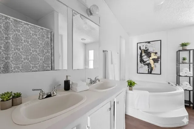a white bath tub sitting next to a white sink