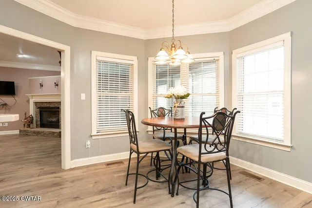 a view of a dining room with furniture wooden floor and chandelier