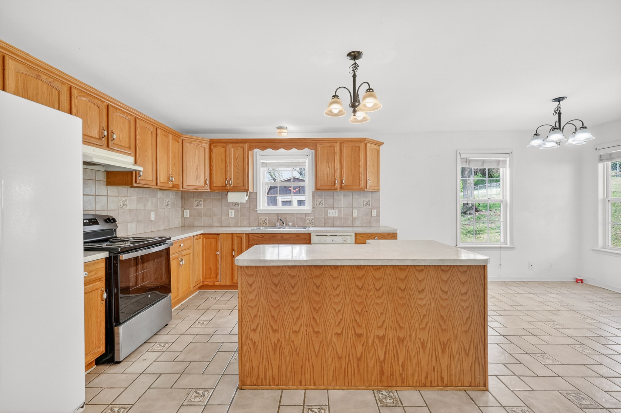 3258 Boyd Mill Avenue Franklin, TN 37064 - Photo 14 of 35 a kitchen with kitchen island granite countertop a sink cabinets and window