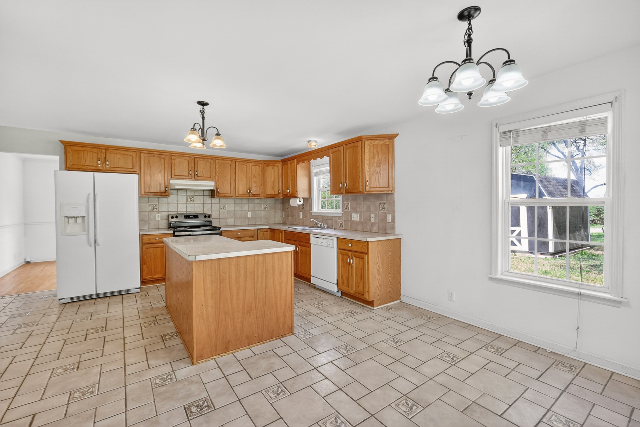 3258 Boyd Mill Avenue Franklin, TN 37064 - Photo 19 of 35 a kitchen with stainless steel appliances granite countertop a stove a sink a refrigerator and a window