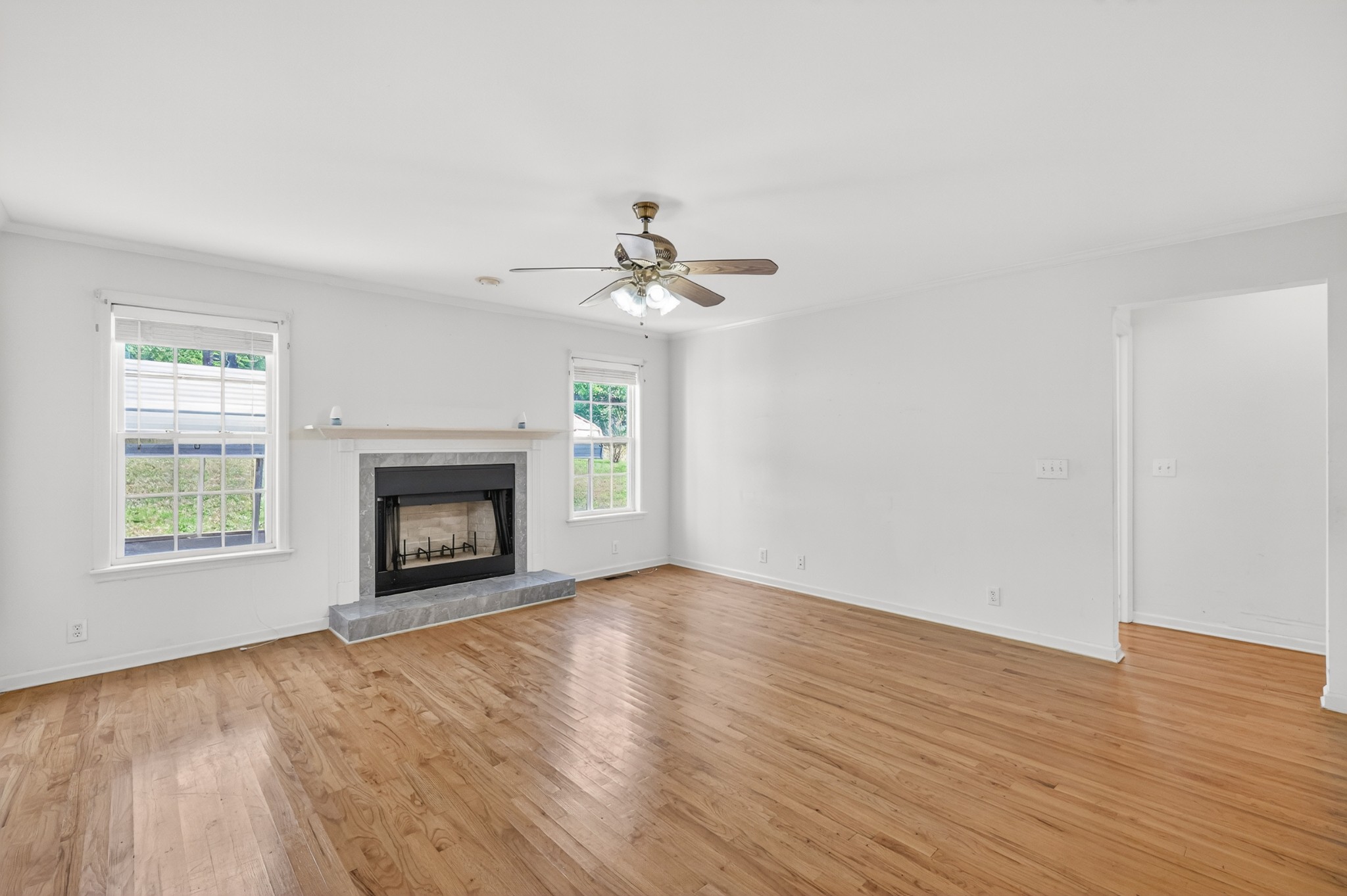 3258 Boyd Mill Avenue Franklin, TN 37064 - Photo 22 of 35 an empty room with wooden floor fireplace and window