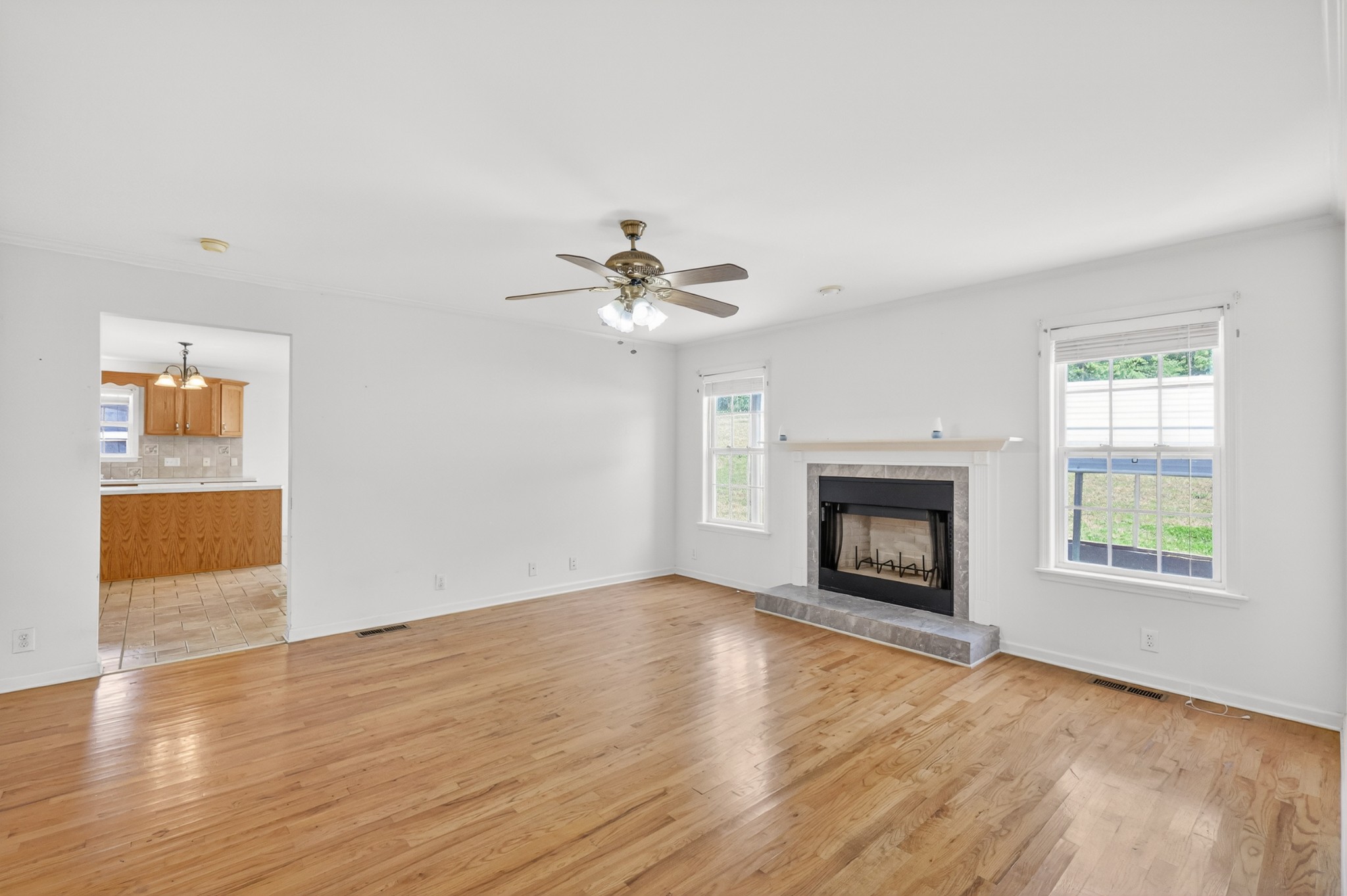 3258 Boyd Mill Avenue Franklin, TN 37064 - Photo 23 of 35 an empty room with wooden floor fireplace and windows
