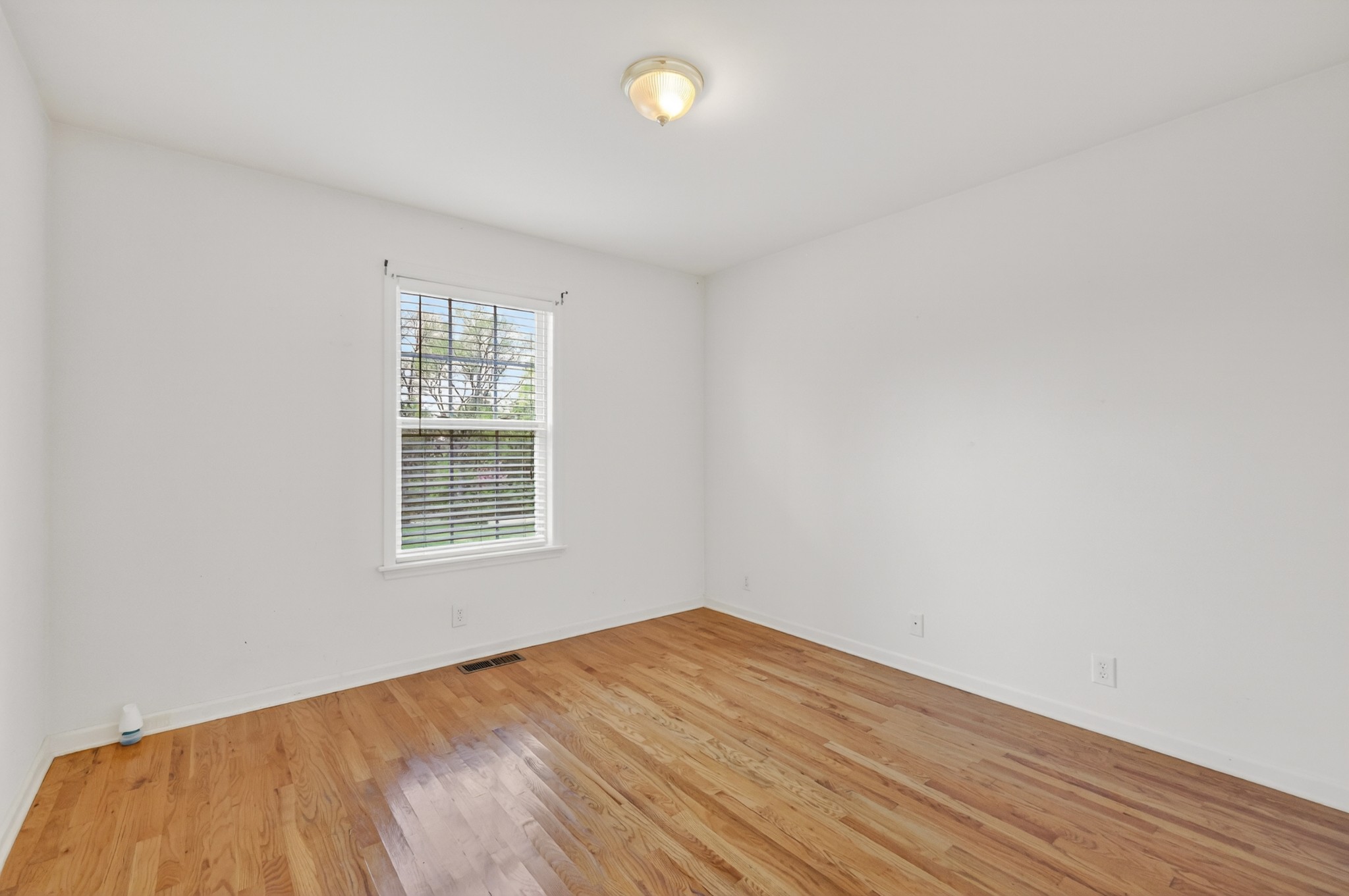3258 Boyd Mill Avenue Franklin, TN 37064 - Photo 28 of 35 an empty room with wooden floor and windows