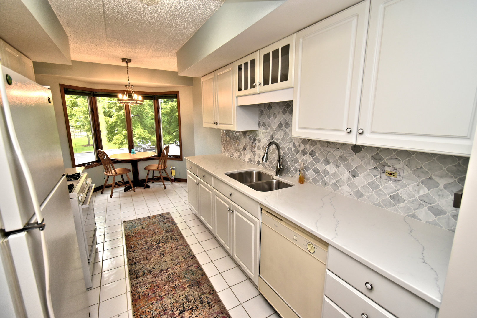 3620 186th Street, Unit 101 Lansing, IL 60438 - Photo 12 of 26 a kitchen with a sink cabinets and window