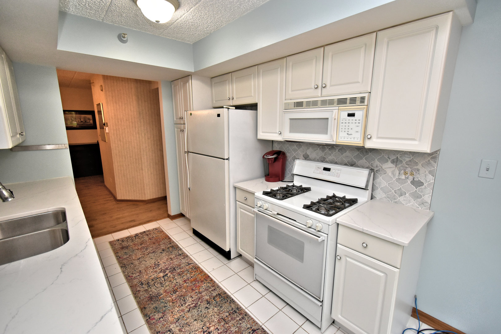 3620 186th Street, Unit 101 Lansing, IL 60438 - Photo 15 of 26 a kitchen with a white cabinets and white appliances