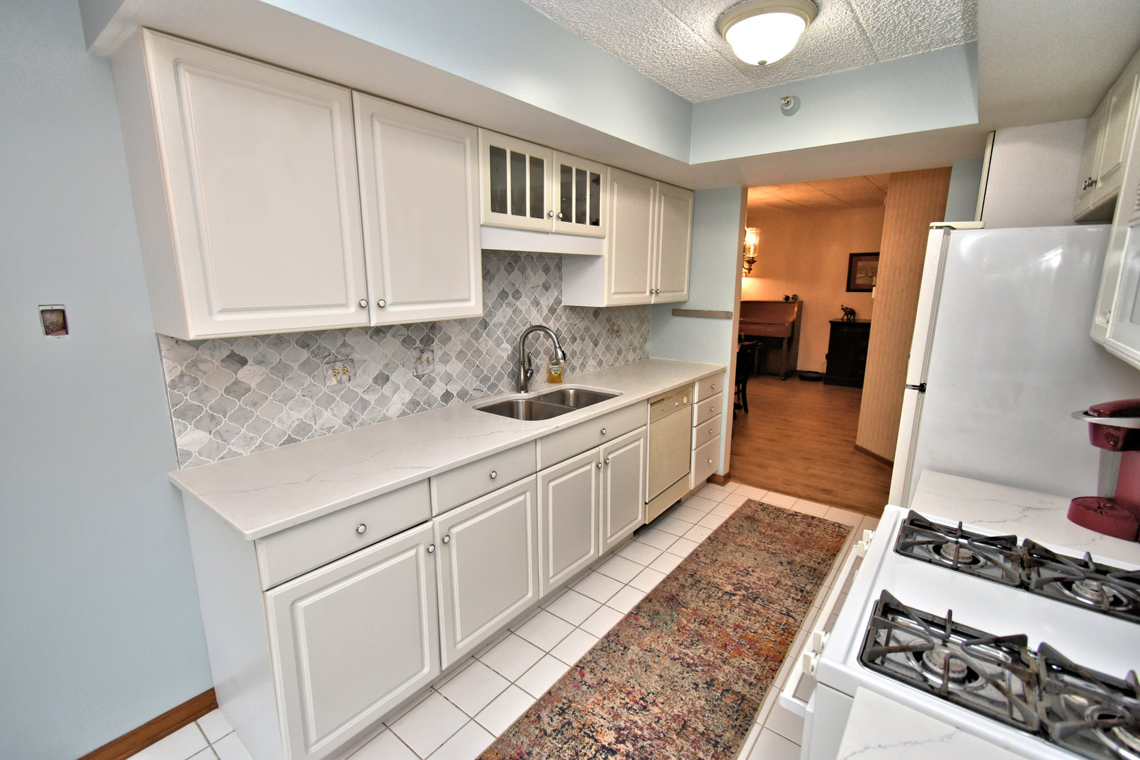 3620 186th Street, Unit 101 Lansing, IL 60438 - Photo 16 of 26 a kitchen with stainless steel appliances granite countertop a sink stove and cabinets