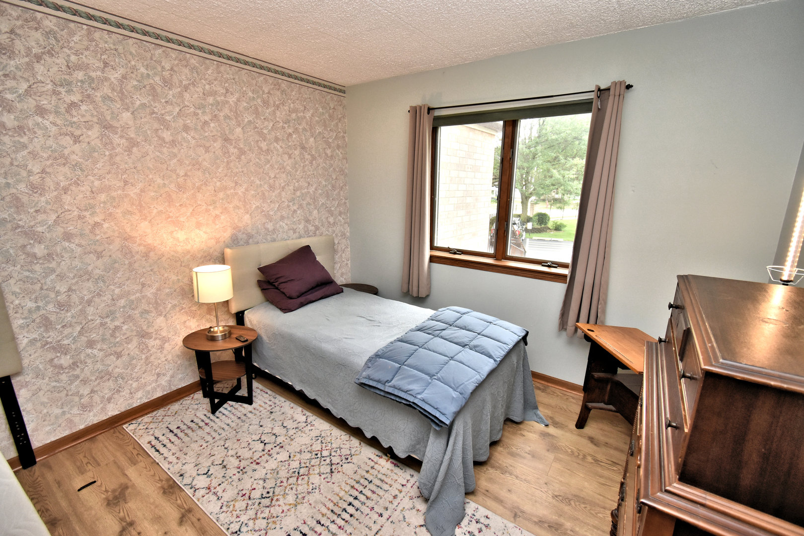 3620 186th Street, Unit 101 Lansing, IL 60438 - Photo 19 of 26 a bedroom with a bed and wooden floor