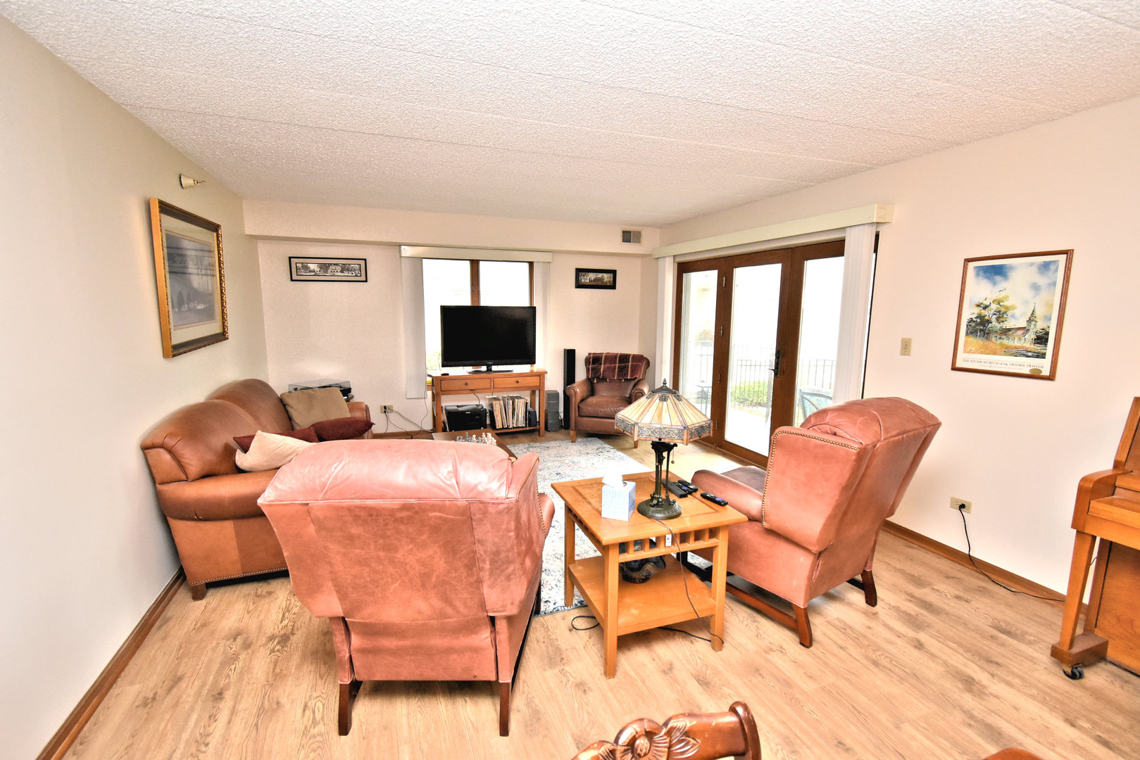 3620 186th Street, Unit 101 Lansing, IL 60438 - Photo 4 of 26 a living room with furniture and a flat screen tv
