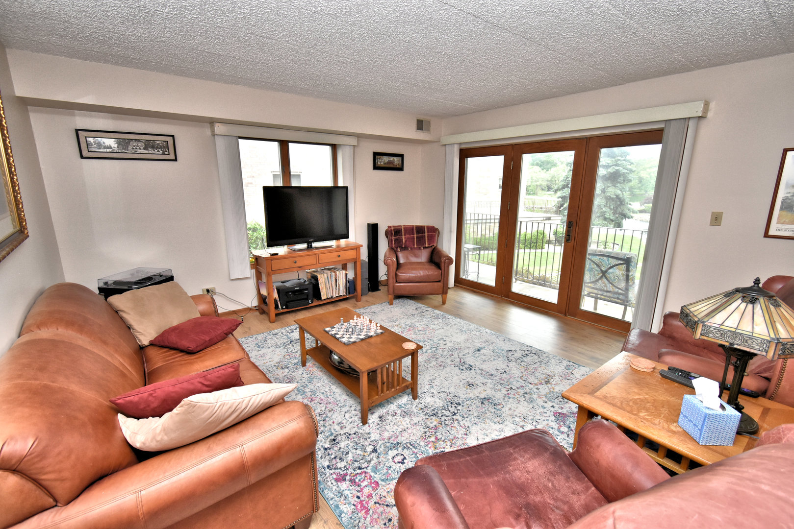 3620 186th Street, Unit 101 Lansing, IL 60438 - Photo 6 of 26 a living room with furniture and a flat screen tv