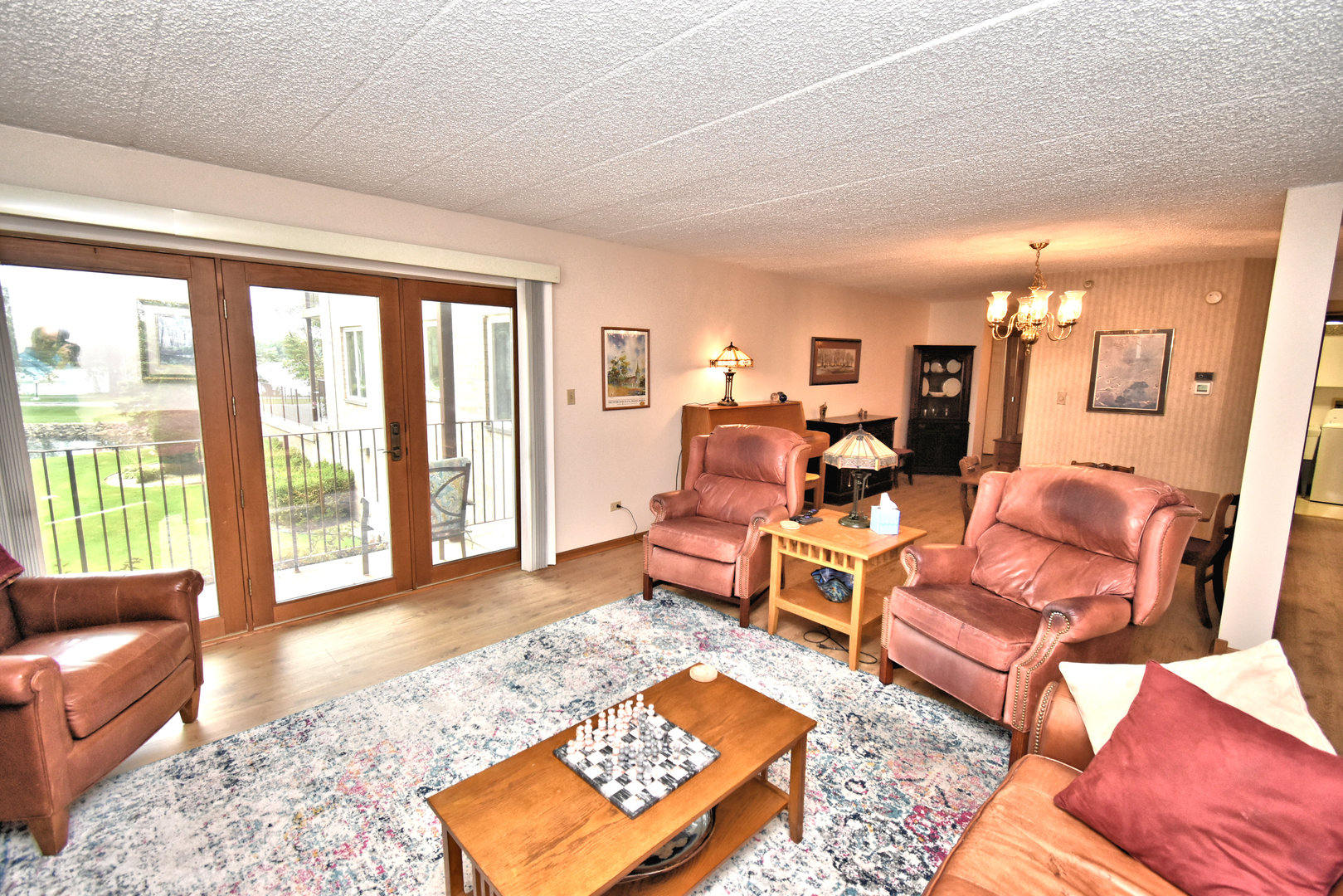 3620 186th Street, Unit 101 Lansing, IL 60438 - Photo 10 of 26 a living room with furniture and a rug