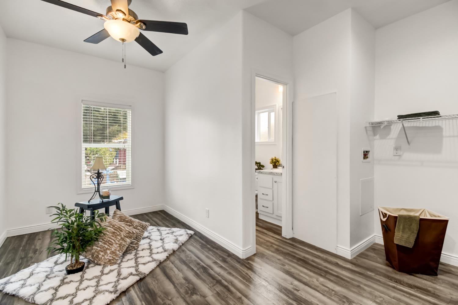 9060 Auburn Folsom Road, Unit 7 Granite Bay, CA 95746 - Photo 11 of 22 a workspace with wooden floor and a chandelier fan