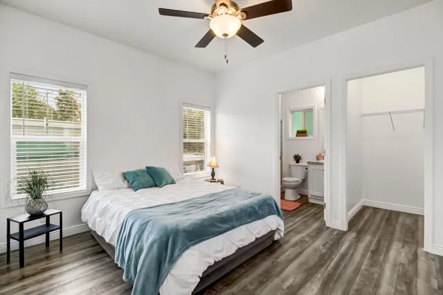 a bedroom with a bed and wooden floor