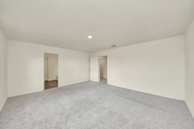 a spacious bathroom with a double vanity sink mirror and toilet
