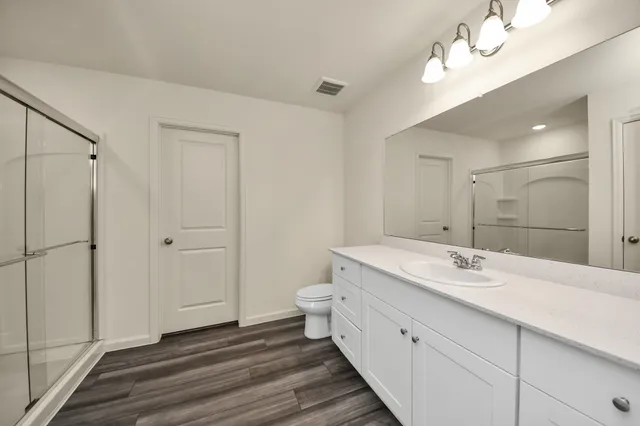 a bathroom with a glass shower door