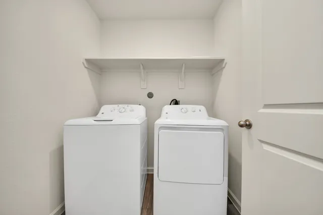 a view of an empty room with a window and closet area