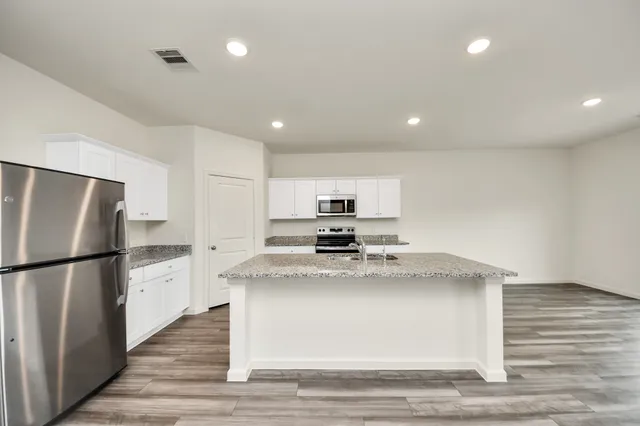 a kitchen with a refrigerator and a sink