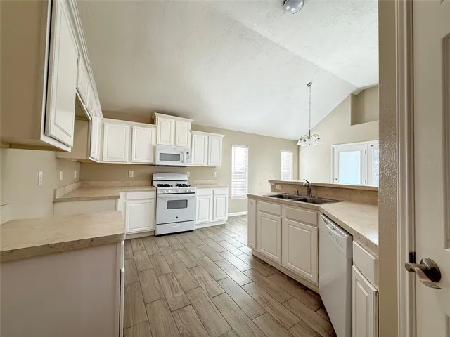 a kitchen with stainless steel appliances granite countertop a stove and cabinets