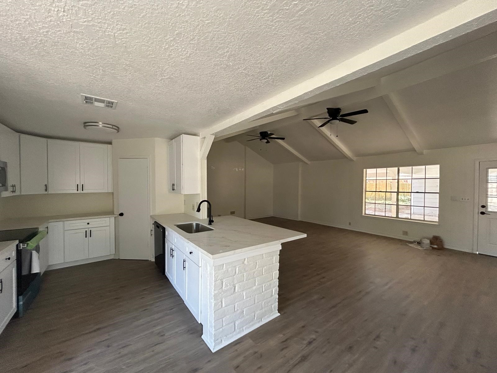 23026 Cranberry Trail Spring, TX 77373 - Photo 2 of 15 a view of a kitchen with a sink dishwasher and wooden floor