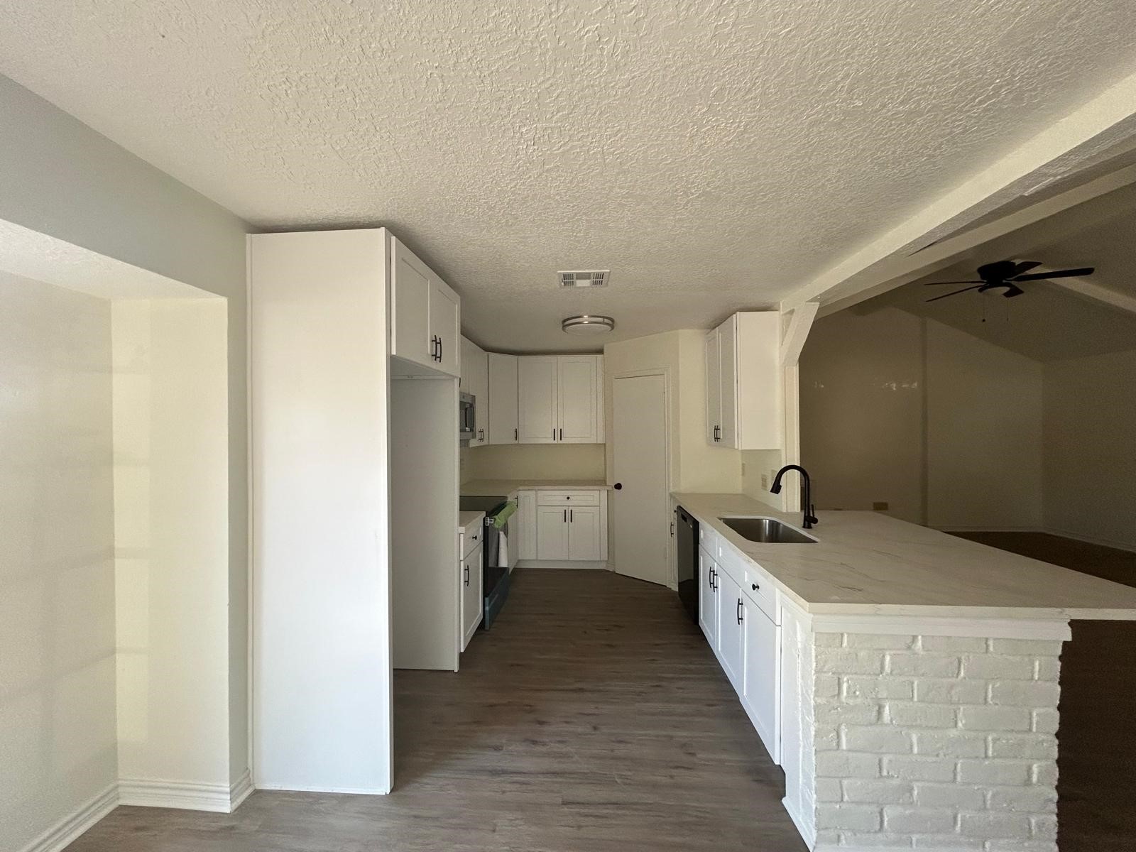 23026 Cranberry Trail Spring, TX 77373 - Photo 4 of 15 a kitchen with a sink stove and cabinets