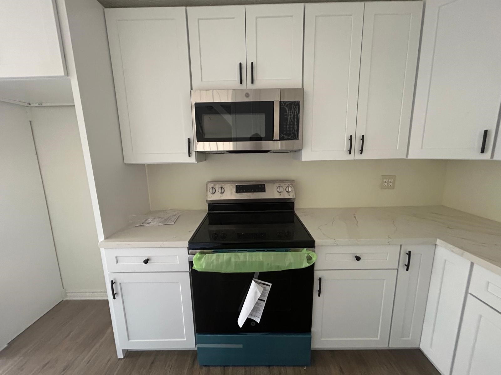23026 Cranberry Trail Spring, TX 77373 - Photo 7 of 15 a kitchen with stainless steel appliances granite countertop a stove a microwave a sink and cabinets