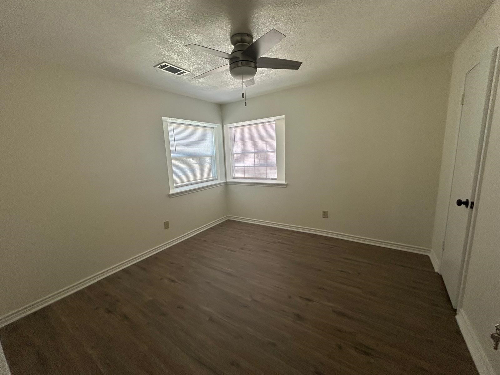 23026 Cranberry Trail Spring, TX 77373 - Photo 8 of 15 en empty room with wooden floor and ceiling fan
