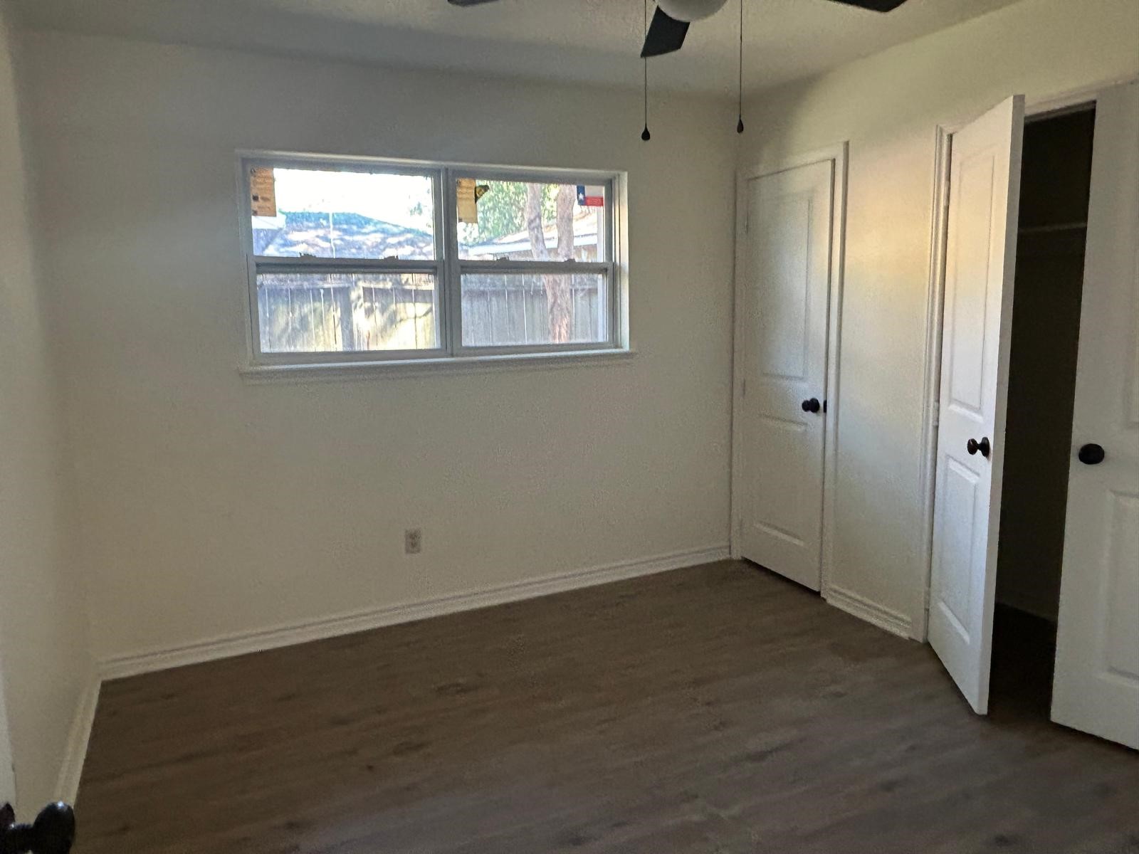 23026 Cranberry Trail Spring, TX 77373 - Photo 9 of 15 a view of an empty room with wooden floor and windows