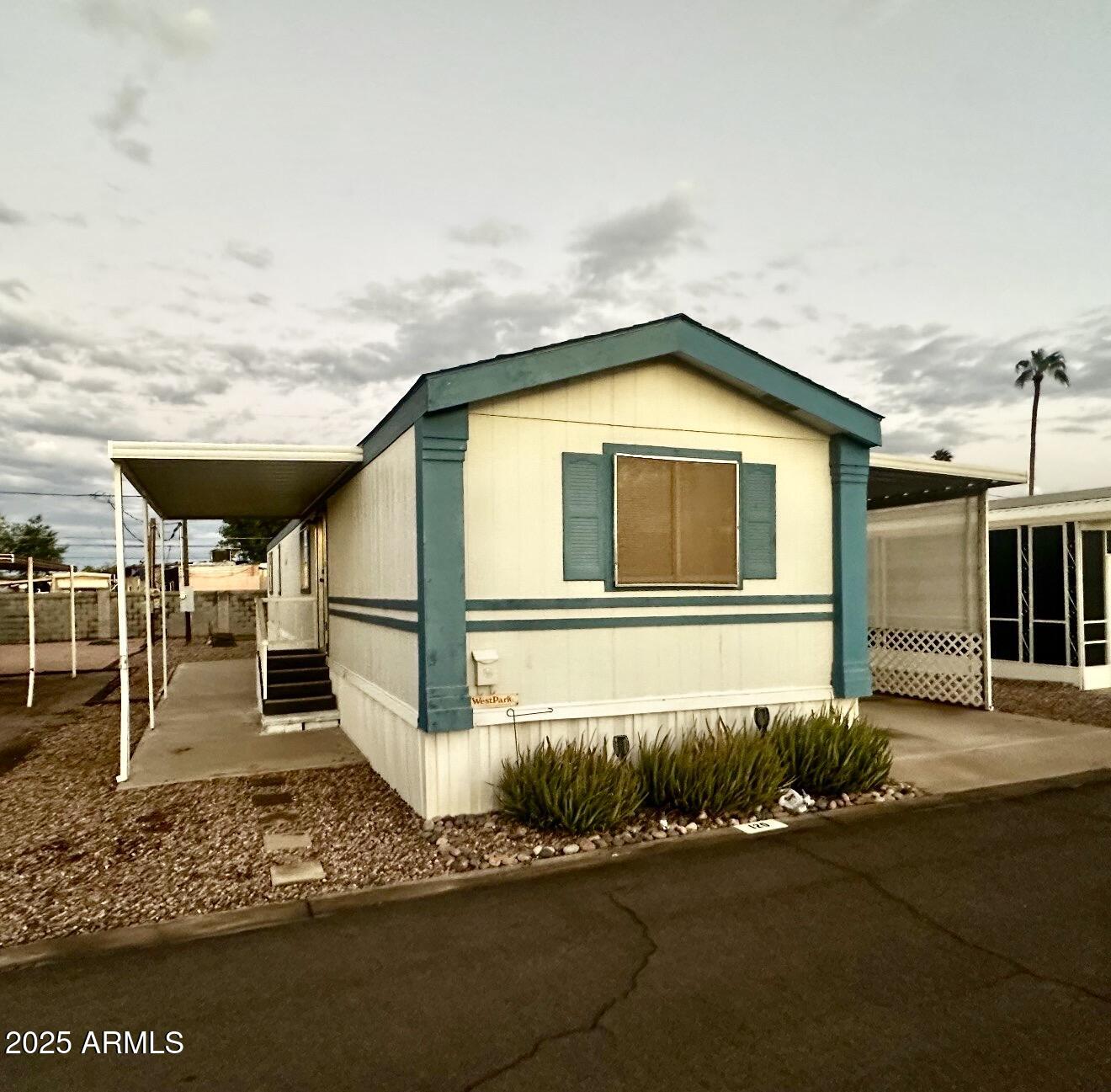 2121 North Center Street, Unit 120 Mesa, AZ 85201 - Photo 1 of 34 a front view of a house with a yard