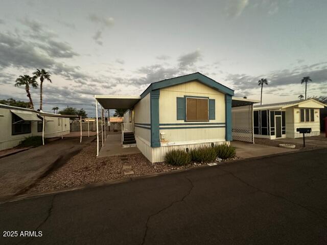 2121 North Center Street, Unit 120 Mesa, AZ 85201 - Photo 2 of 34 a front view of a house with a garden